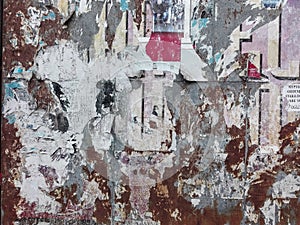 Bulletin board with torn papers. Torn posters on a wooden noticeboard.