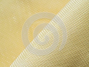 Bulletproof material aramid. Shining aramid kevlar background. Golden kevlar texture and pattern