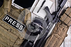 Bulletproof vest,camera,rifle,notebook,army belt and tablet touch computer.Top view