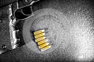 Bullets and handcuffs. Close-up of 9mm pistol. Gun and weapon with bullets amunition on black backround. Top view.