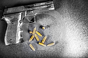 Bullets and handcuffs. Close-up of 9mm pistol. Gun and weapon with bullets amunition on black backround. Top view.