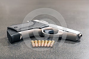 Bullets and Handgun on Black Table