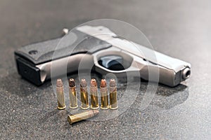 Bullets and Pistol on Black Counter