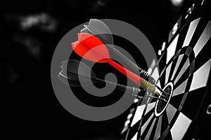 Bullseye or Bulls eye target or dartboard has red dart arrow throw hitting the center of a shooting for financial business
