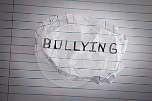 Bullying. Crumpled paper ball with word Bullying