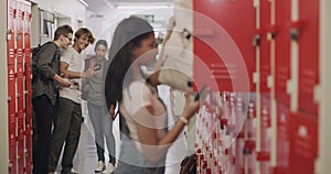Bullying, depression and stress for sad high school girl at the locker with phone. Children, bullies and cyber bully