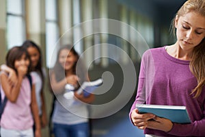 Bullying happens everywhere. A young girl getting teased at school.