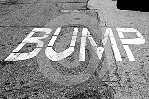 BUMP sign painted on the road