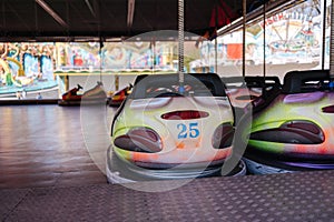 Bumper car at fun fair. Colorful electric cars in amusement park