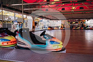 Bumper car at fun fair. Colorful electric cars in amusement park