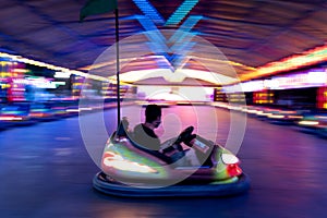 A bumper car in the middle of the stage in a fair