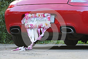 Bumper of limousine with just married sign attached.