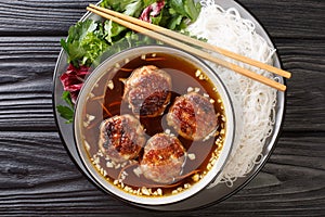 Bun cha Hanoi is a delicious Vietnamese street food combining flavorful meatballs, rice noodles and dipping sauce. Horizontal top photo