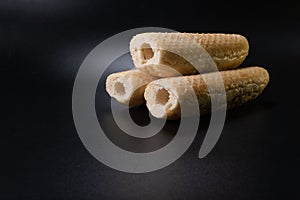 Bun for french hot dog on a black background. Fast food bakery product. production. Copy space