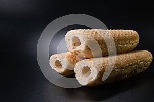 Bun for french hot dog on a black background. Fast food bakery product. production. Copy space