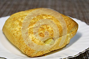 Bun on a plate on the table.