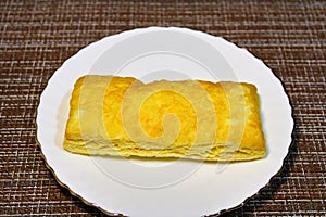 Bun on a plate on the table.