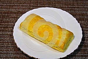 Bun on a plate on the table.