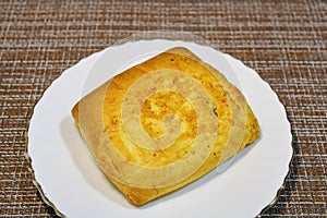 Bun on a plate on the table.