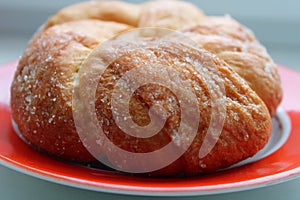 Bun on a plate on the table.