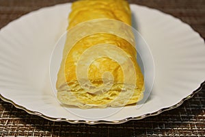 Bun on a plate on the table.