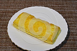 Bun on a white plate on the table.