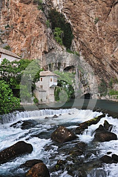 The Buna river with a waterfall flowing out of the cave, as well as the tekkia - an ancient dervish home, monks, Blagaj