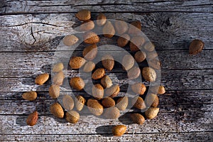 Bunch of almonds unshelled, badam, forest fruit harvest on wood photo