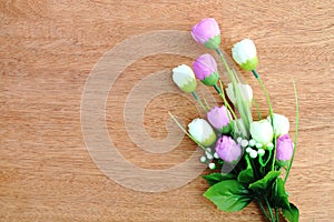 Bunch of artificial flower on wooden background