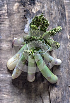 A bunch of asparagus on a wooden background