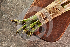 Bunch of asparagus on wooden cutting board