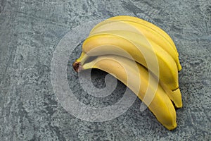 Bunch of bananas on a biton background. Top view