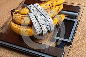 Bunch of bananas lying on floor scales