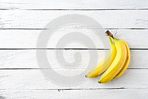 Bunch of bananas on white wooden background. Fruit background