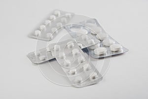 A bunch of blister packs of pills on white background,