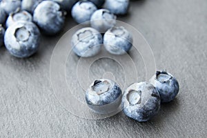 Bunch of blueberry berries close-up on a dark stone background