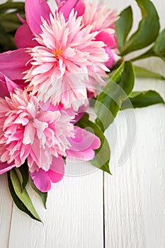 Bunch, bouquet of pink peonies on a wooden background. Frame of flowers