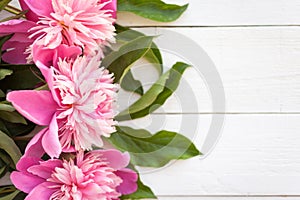 Bunch, bouquet of pink peonies on a wooden background. Frame of flowers