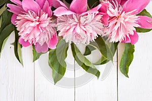 Bunch, bouquet of pink peonies on a wooden background. Frame of flowers