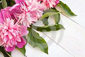 Bunch, bouquet of pink peonies on a wooden background. Frame of flowers