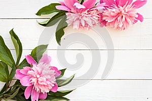 Bunch, bouquet of pink peonies on a wooden background. Frame of flowers