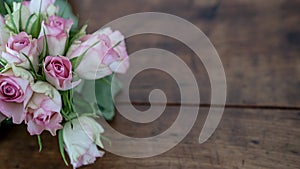 Bunch bouquet of pink roses on rustic wooden table - Flower background panorama banner vintag photo