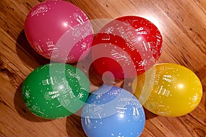 Bunch of bright balloons party. Colorful carnival or party background of balloons, streamers and confetti on wooden parquet