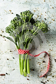 Bunch of broccolini on a stone surface