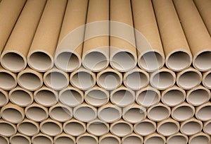 A bunch of brown industrial paper core. A lot of paper cores or paper tubes. photo