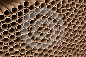 A bunch of brown industrial paper core. A lot of paper cores or paper tubes. photo