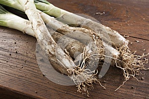 Bunch of calÃ§ots on wooden table