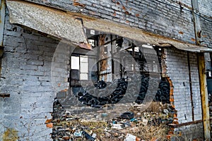 A bunch of car tires are in an abandoned factory. View of old factory inside. Close-up