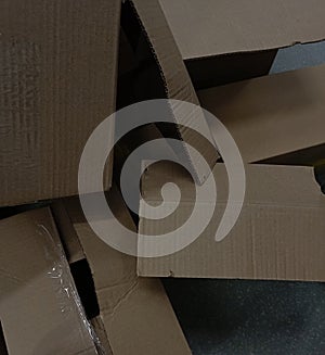 A bunch of cardboard boxes are lying on the floor