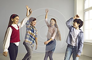 Bunch of cheerful kids dancing, laughing, having fun and enjoying their free time